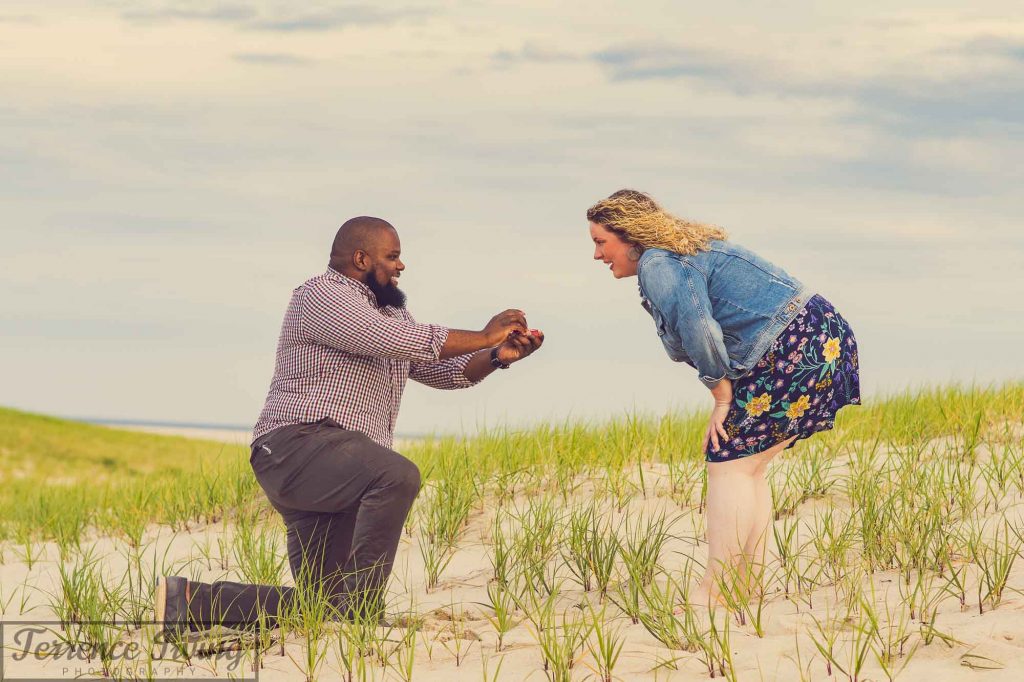 Epic proof for answering the question of how to photograph your own proposal. The photographer, down on one knee, presents an engagement ring to his partner as she stands in disbelief.