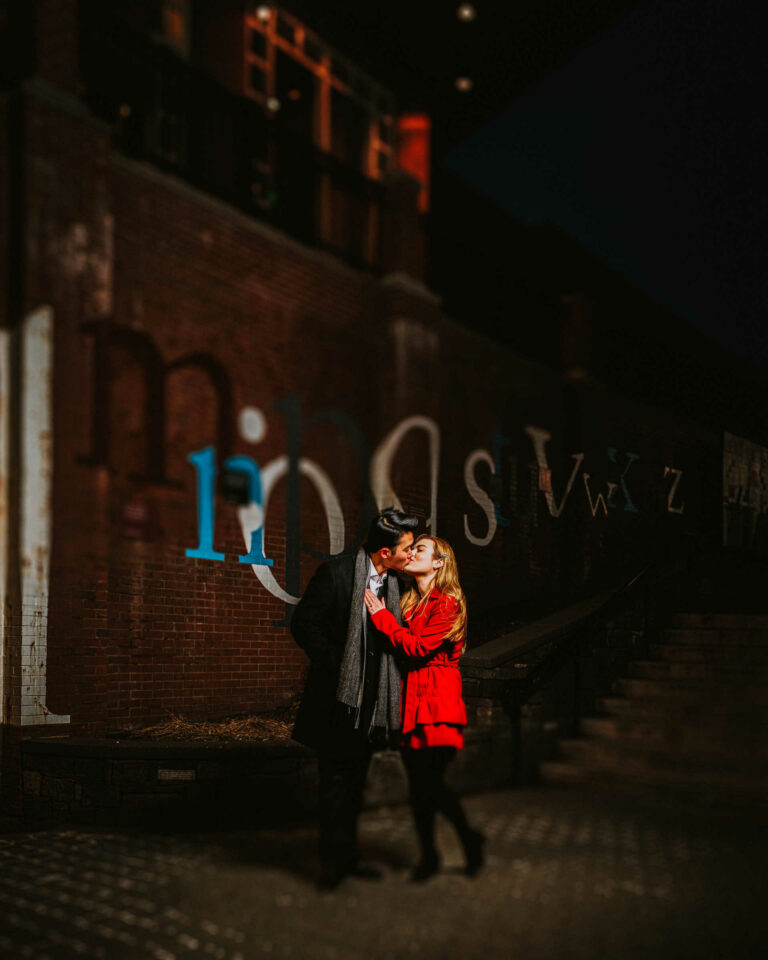 An engaged couple kisses during their West Hartford Blue Back Square engagement session.