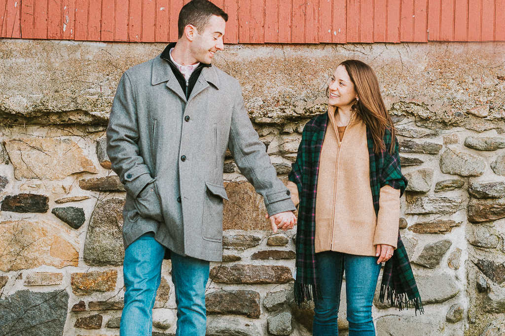 An engaged couple holds hands during their University of Connecticut engagement session.