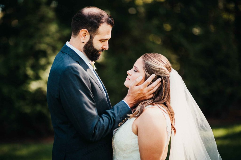The Hops Company, among the great beer wedding venues in Connecticut, hosts a bride and groom who embrace.