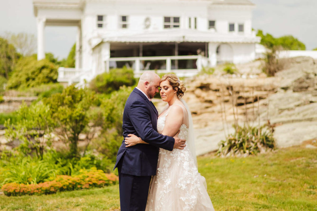 A bride and groom embrace at Mystic wedding venue Inn at Mystic.