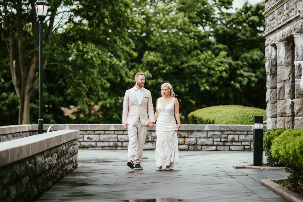 A bride and groom walk hand-in-hand during their Branford House wedding.