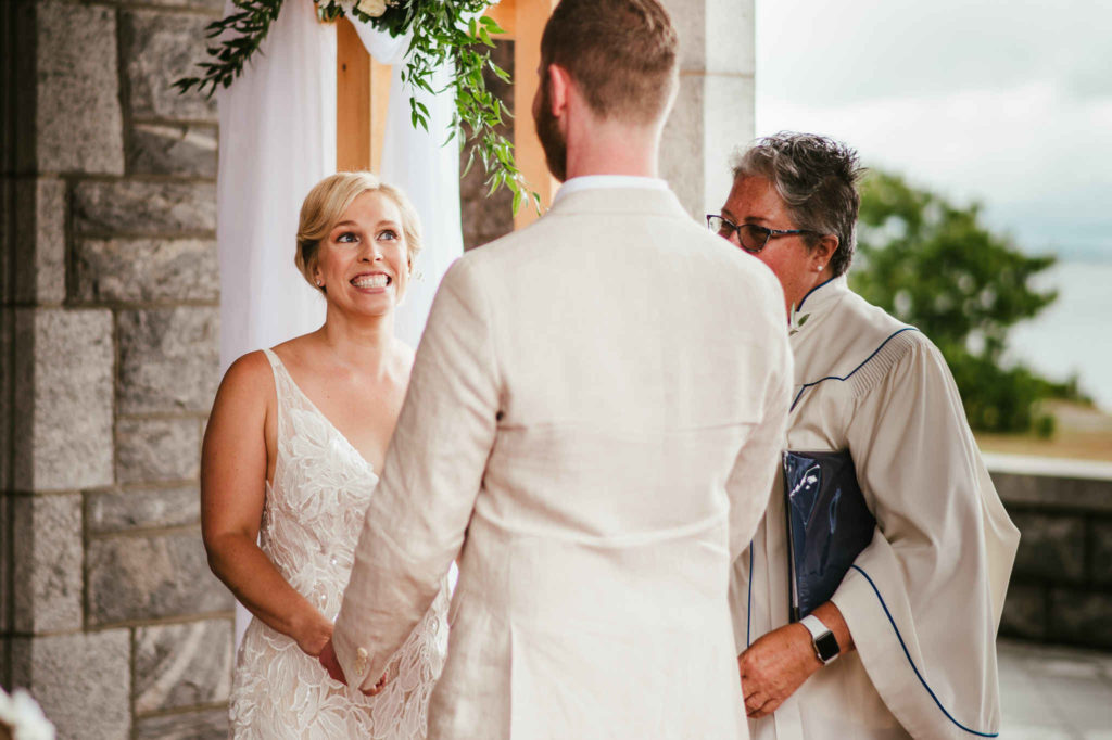 A bride smiles at her groom during their Branford House wedding ceremony.