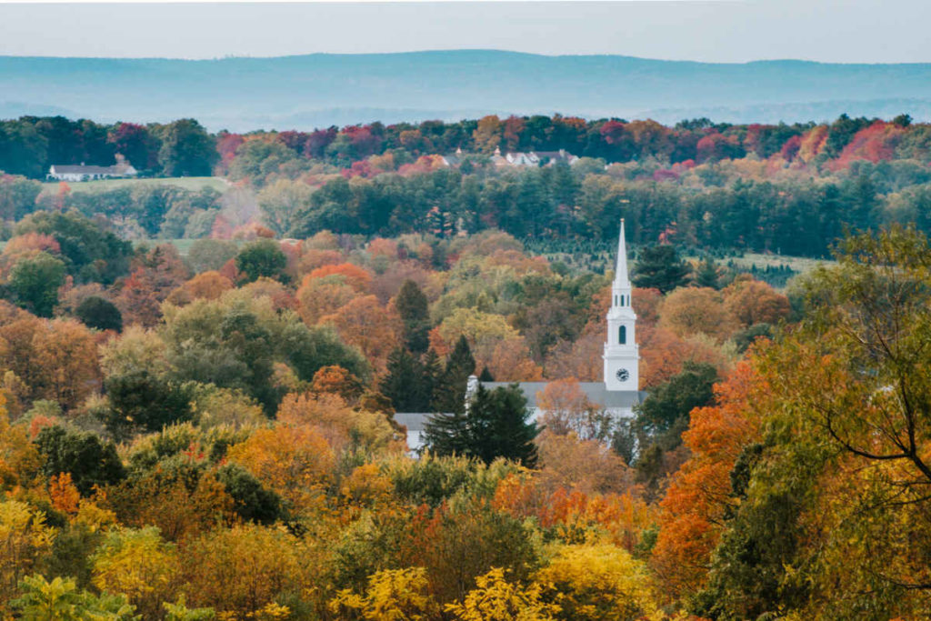 A white church among fall foliage, then by Connecticut proposal photographer Terrence Irving.