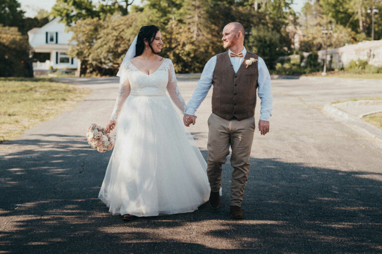 A bride and groom hold hands during their minimony or elopement in Connecticut.