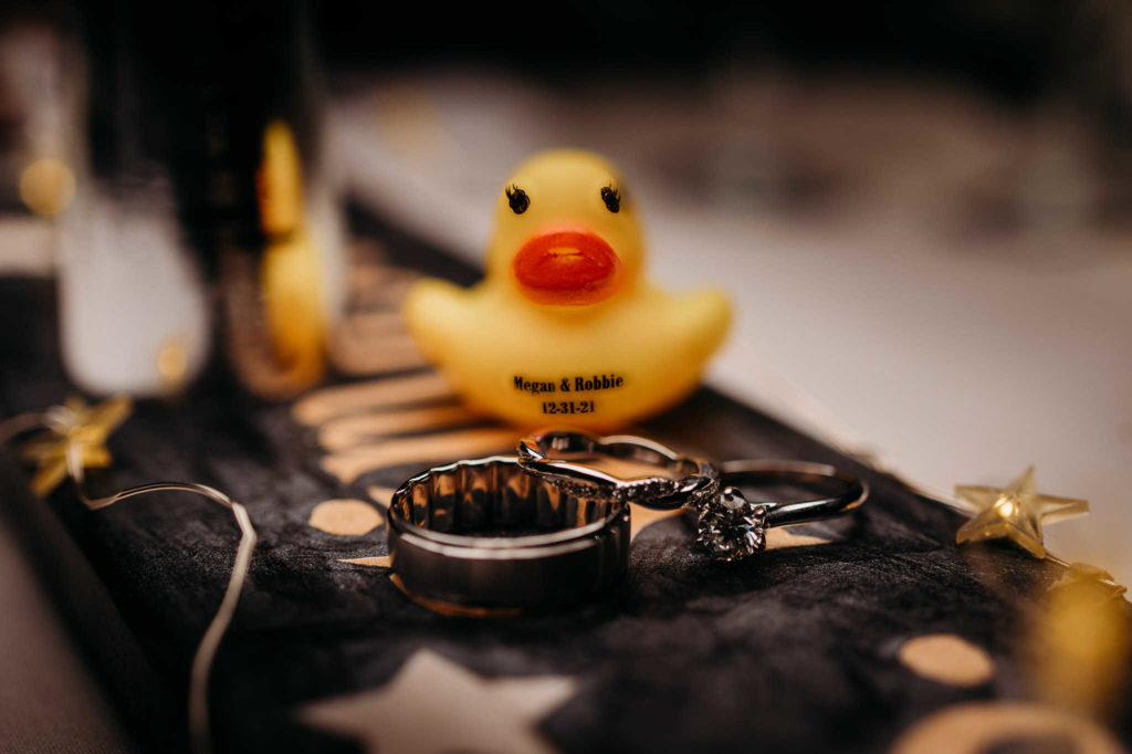 A rubber duck and wedding rings during a new year's eve wedding.