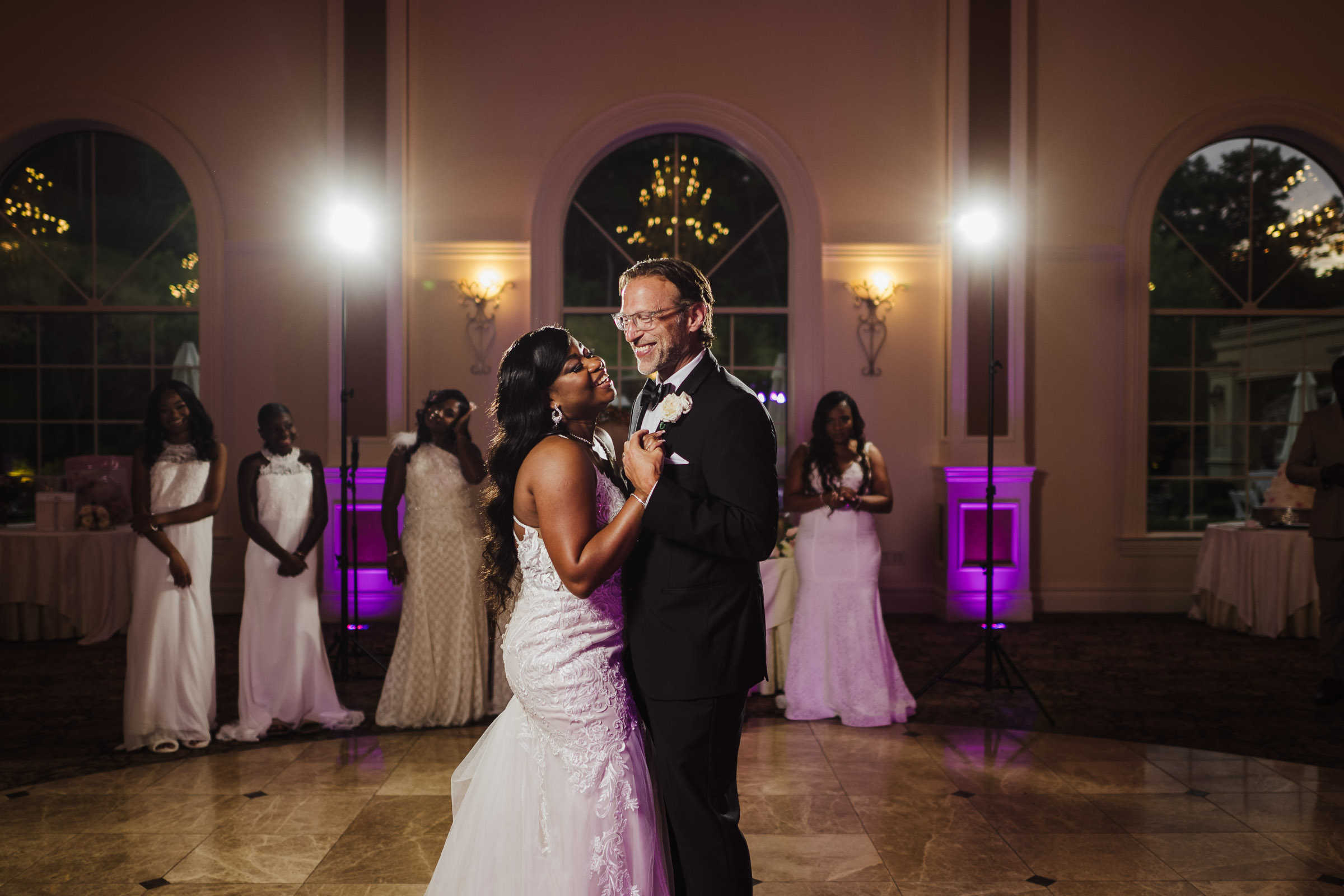 A bride and groom dance inside a ballroom during their Aria wedding night.