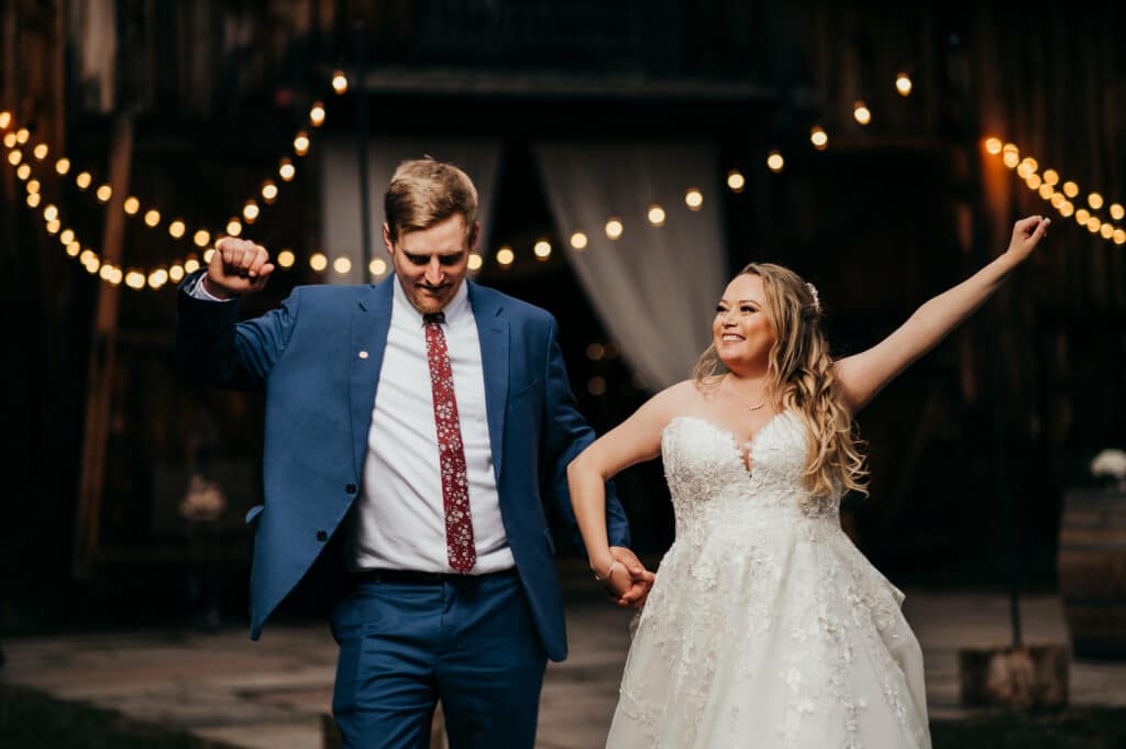 A photo of a bride and groom dancing in front of a rustic barn by Connecticut wedding photographer Terrence Irving.