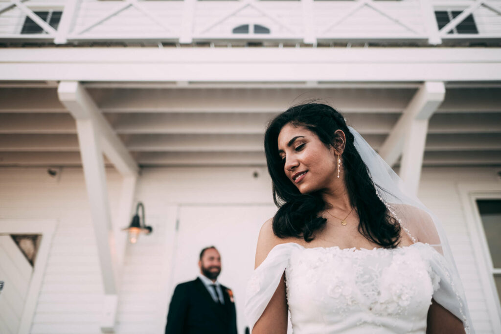 A bride and groom who planned their wedding in Connecticut on a budget pose at their affordable wedding venue in CT.