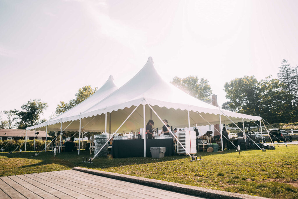 A tent's interior is prepared by caterers before a Connecticut River Museum wedding.