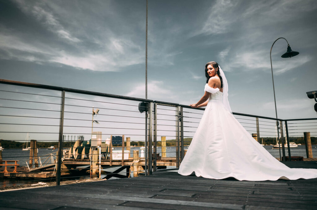 A bride poses on the dock during her Connecticut River Museum wedding.