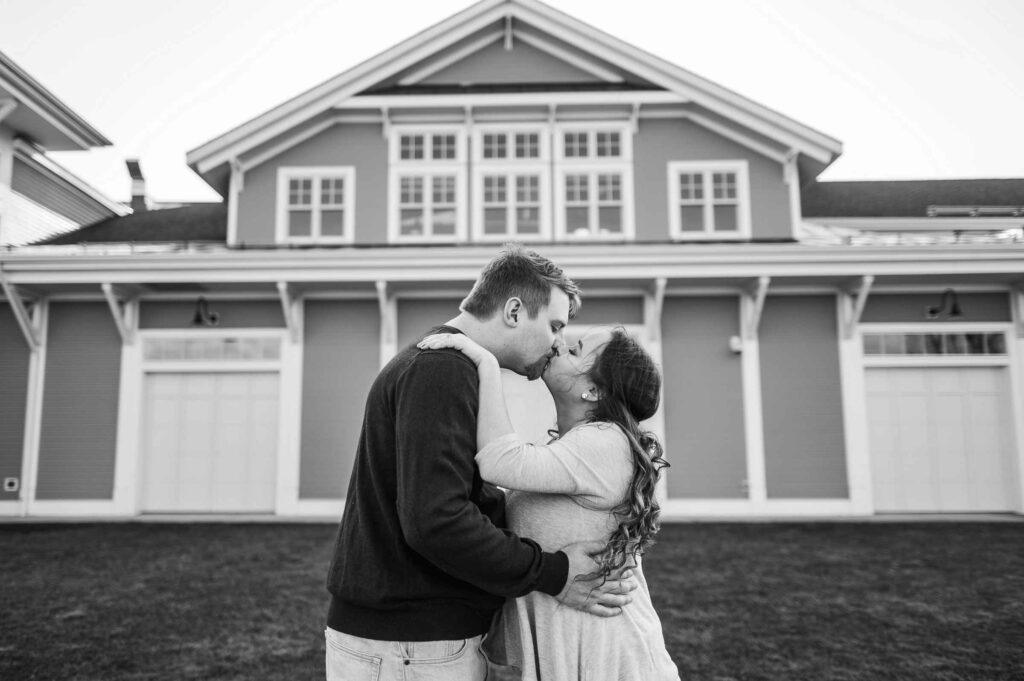 A couple enjoys a kiss at The Glastonbury Boathouse, an industrial wedding venue in Connecticut.