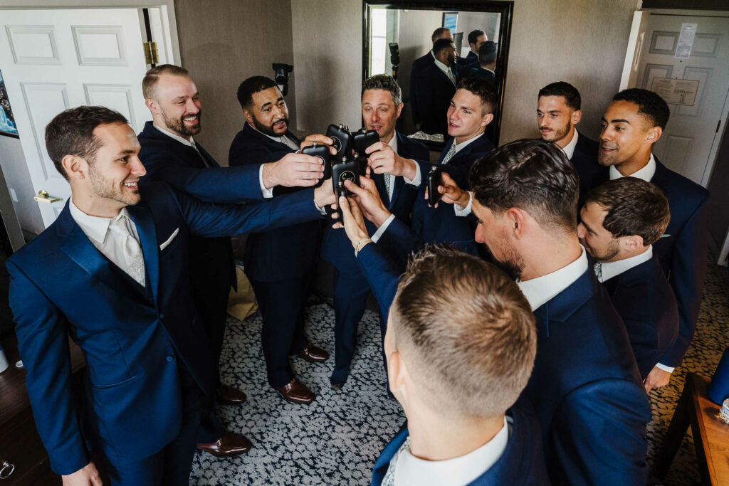 Groomsmen toast the groom before an Inn at Middletown wedding.