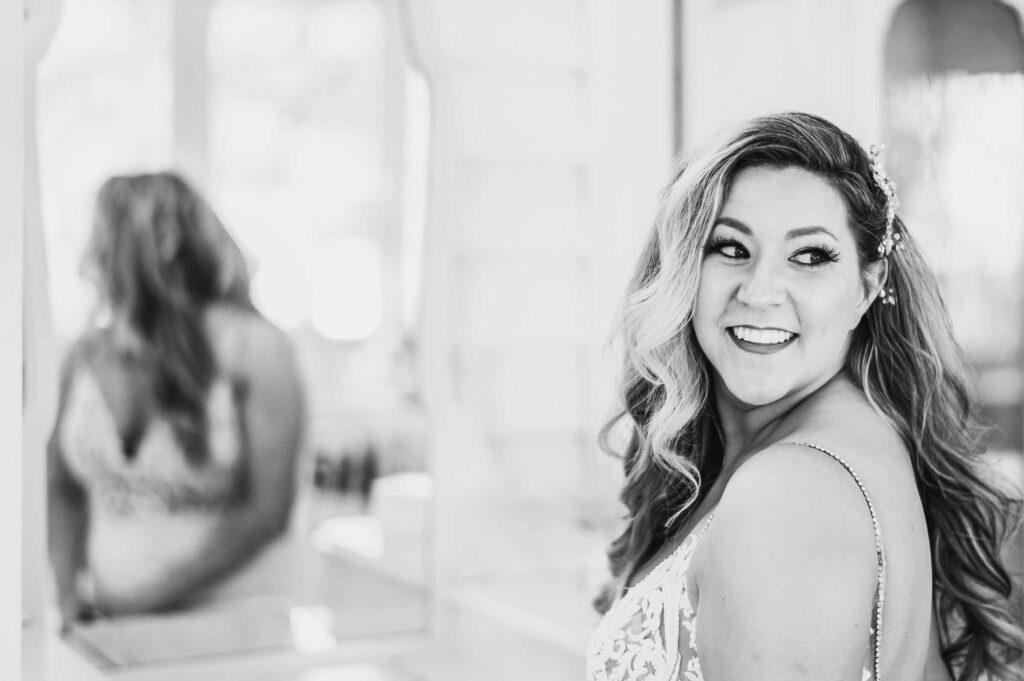 A bride smiles while getting ready at KISS Spa before her Lord Thompson Manor wedding.