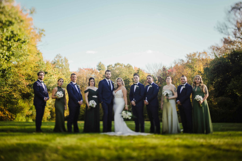 The bride and groom pose with their wedding party during their Connecticut mansion wedding.