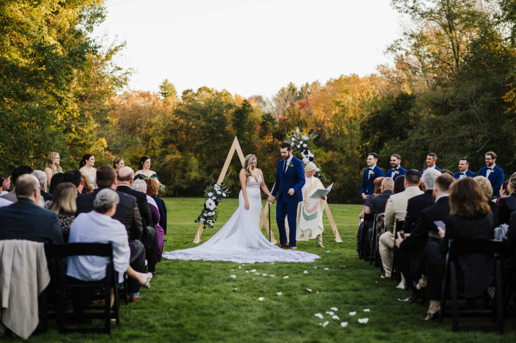 A wedding ceremony takes place at Connecticut's Lord Thompson Manor.