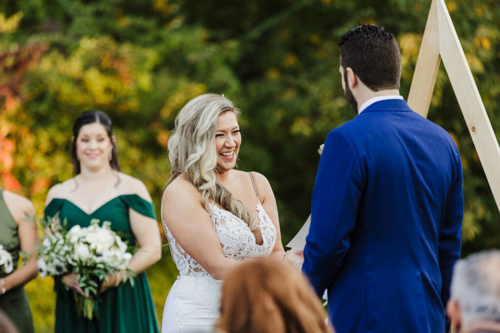The bride laughs with the groom during the Connection mansion wedding ceremony.