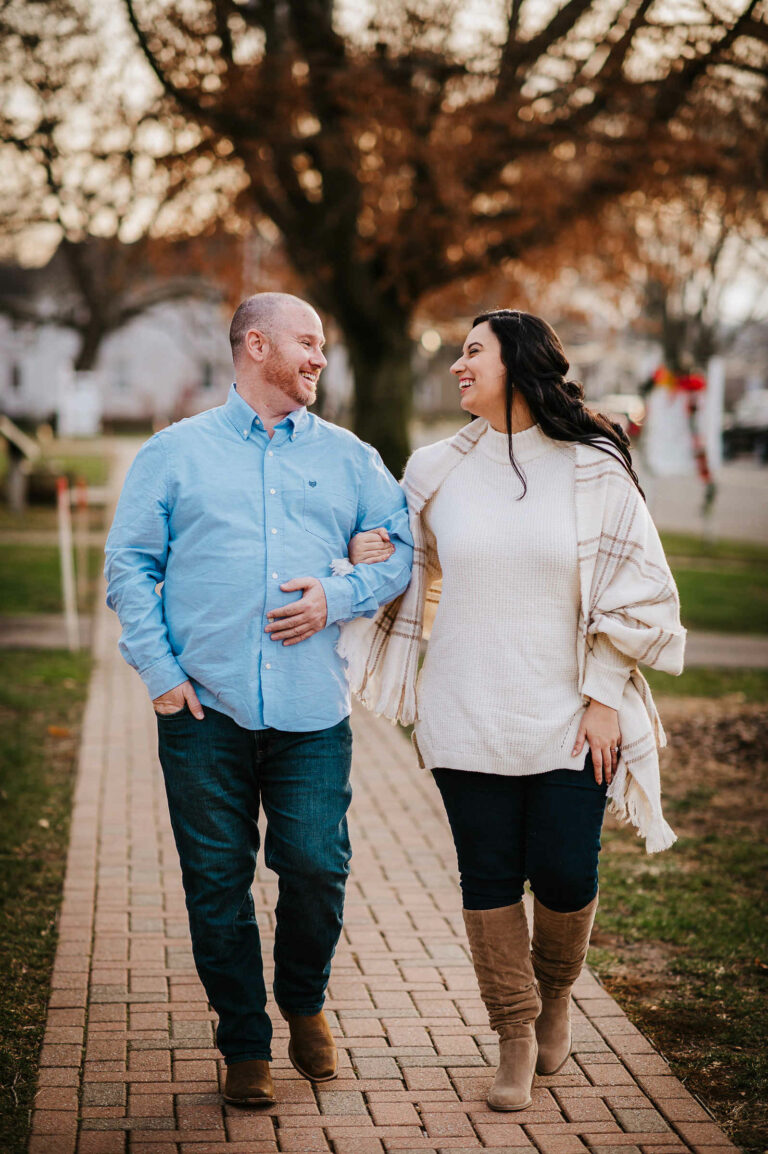 A couple walks arm in arm during their Wethersfield engagement session.