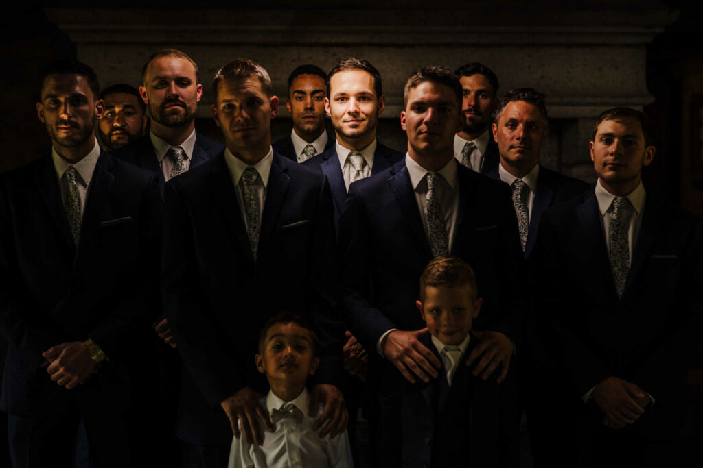 A groom poses with his groomsmen during his Saint Clements Castle wedding.
