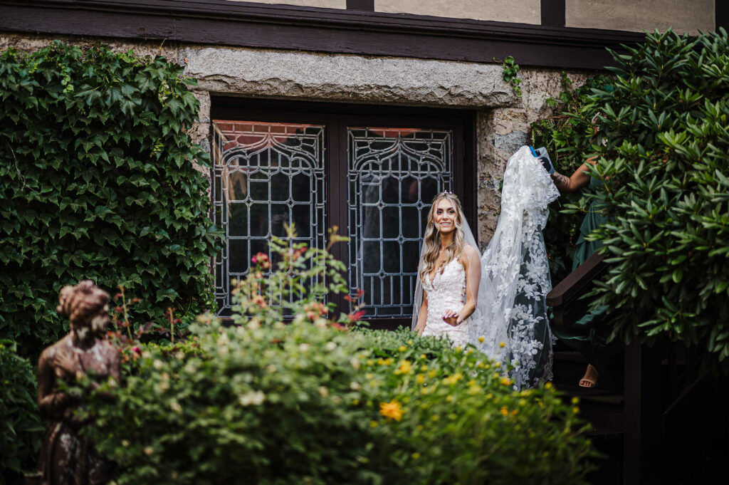 A bride walks outside for her first look during her St. Clements Castle wedding.