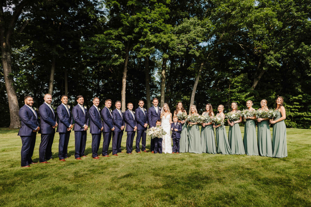 A bride, groom, and their wedding party pose during their Portland CT wedding.