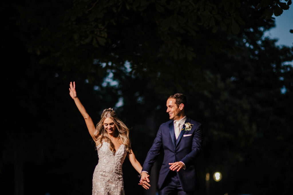 A bride and groom hold hands and dance during their St. Clements Castle wedding.