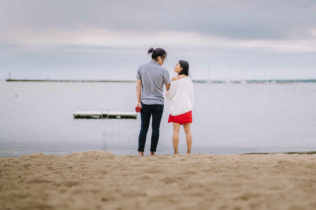 A Connecticut proposal photo shows a man and woman standing on a beach.