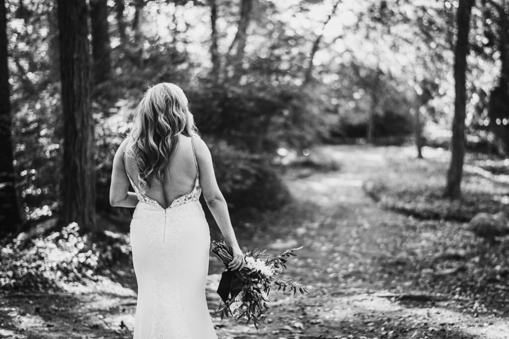 A bride walks to the first look of her Connecticut mansion wedding.