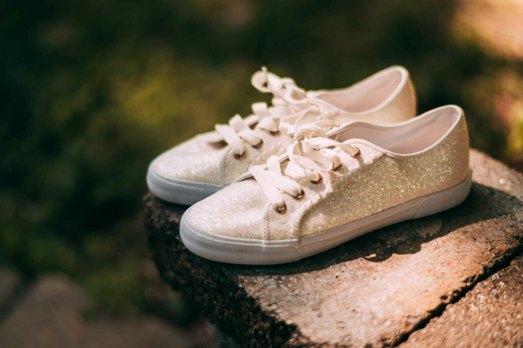 A bride's sneakers sit on a ledge before her Brooklyn barn wedding.