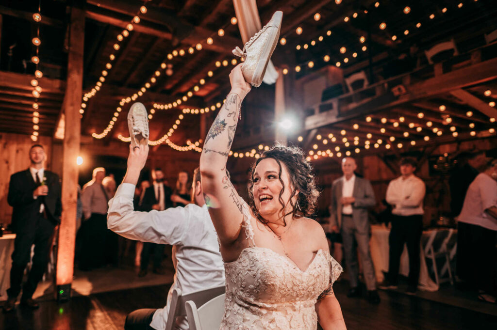 A Connecticut wedding planner orchestrated this rendition of “the shoe game” in which the bride and groom are holding up shoes during their wedding reception.  