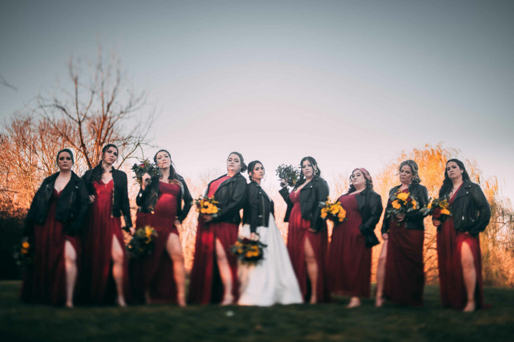 A bride and bridesmaids pose during her wedding at The Barns at Wesleyan Hills.