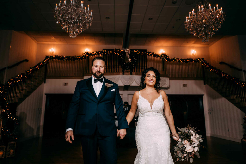 A bride and groom enter their reception at Connecticut wedding venue Cascade in Hamden.