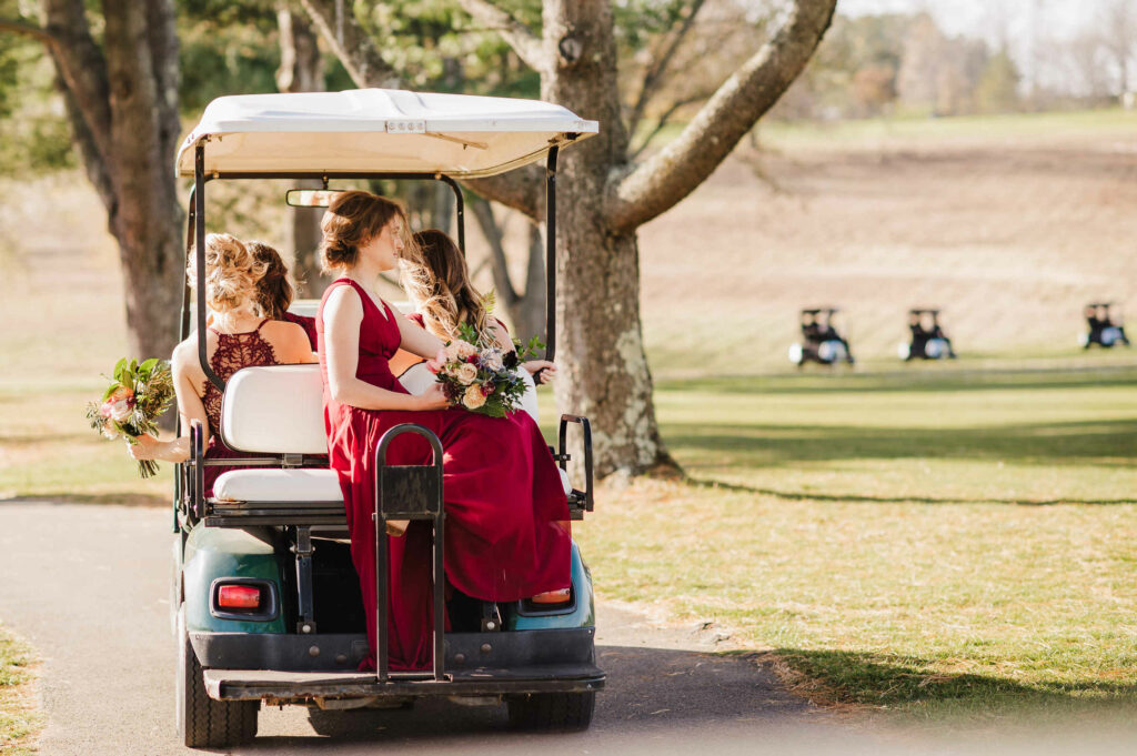 The wedding party drives around in golf carts during a wedding at Lyman Orchards.