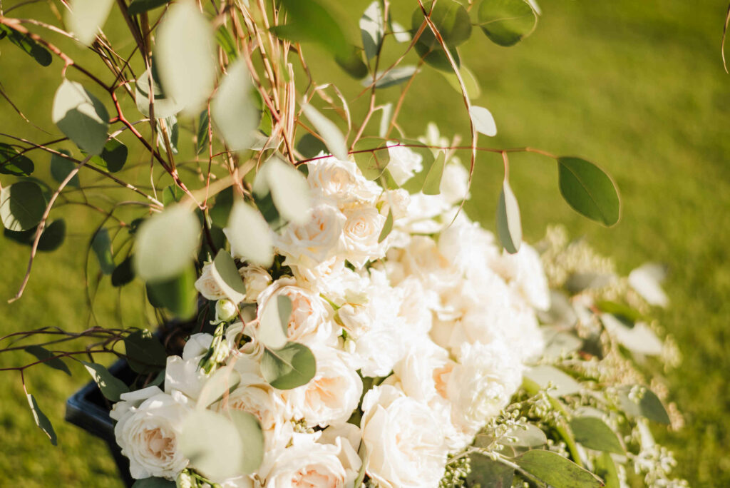 White flowers decorate a chair during a Lyman Orchards wedding ceremony.