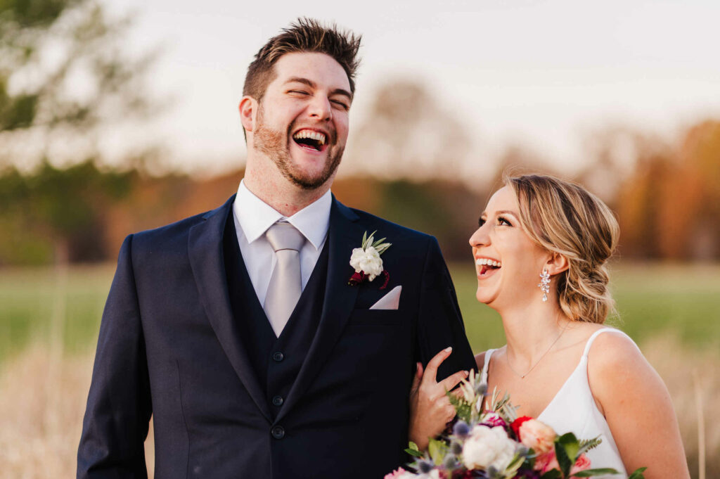 A photo of a laughing bride and groom taken by Terrence Irving while working as the second wedding photographer at a golf course wedding.