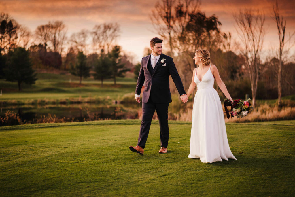A bride and groom walk at the best country/golf club CT wedding venue, Lyman Orchards.