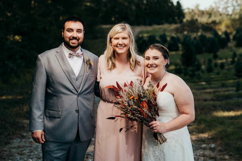 Colleen Horstmann, a Connecticut wedding planner, is pictured with a bride and groom on their wedding day.