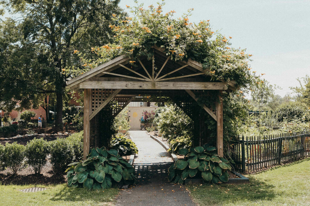 A covered walkway adorned with plants before a wedding in Elizabeth Park.