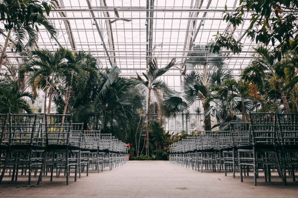 The main building is set up with Chivari guest chairs for a Roger Williams Botanical Center wedding.