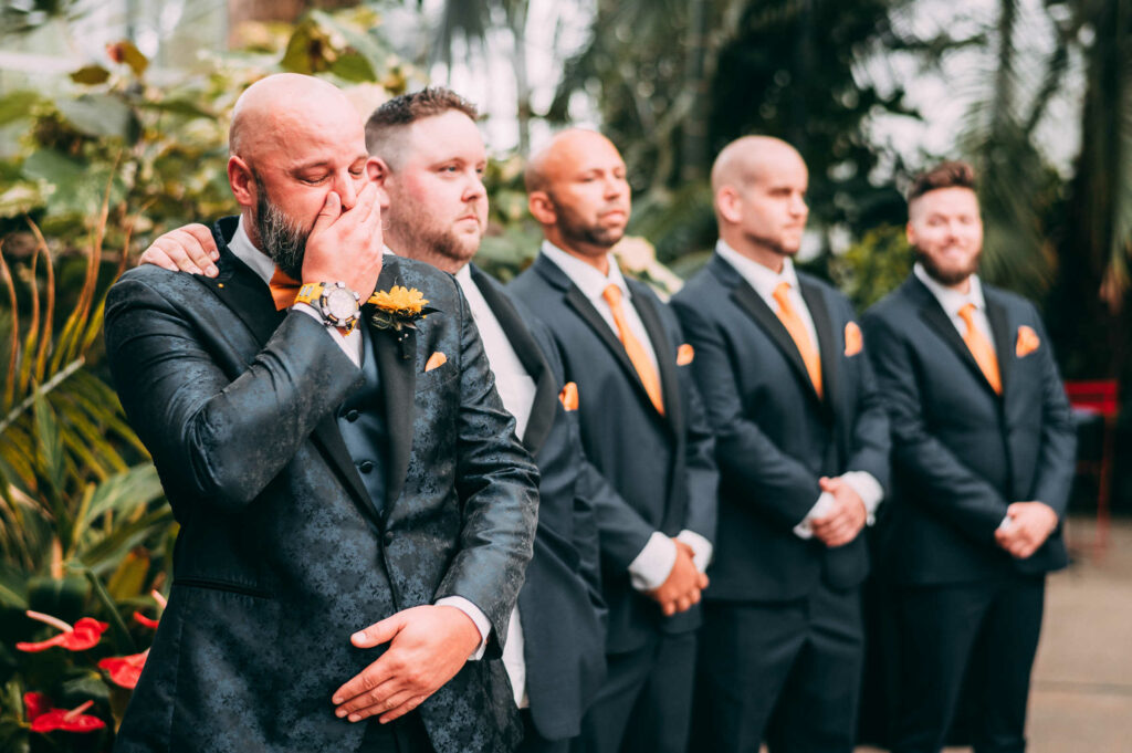 The groom cries while seeing the bride for the first time at his wedding at Roger Williams Botanical Center.