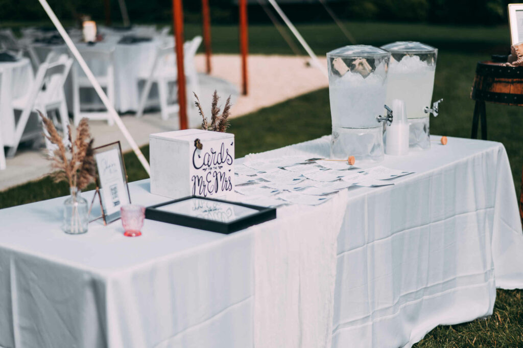 A table for cards and refreshments is pictured during a hops company wedding.