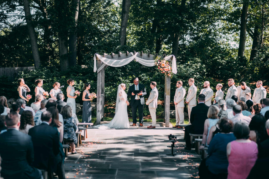 A ceremony takes place on the patio at The Garden at The Hops Company in Derby CT.