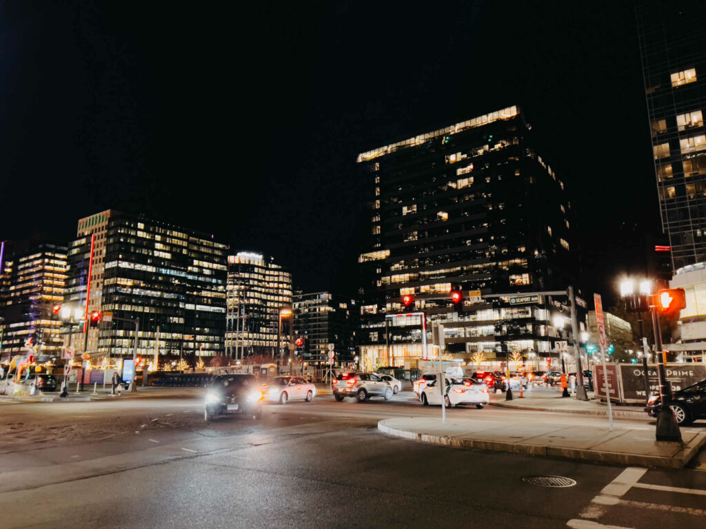 The Boston city skyline is great to incorporate into an engagement session. Here, the Waterfront neighborhood is pictured at night with stoplights and cars.