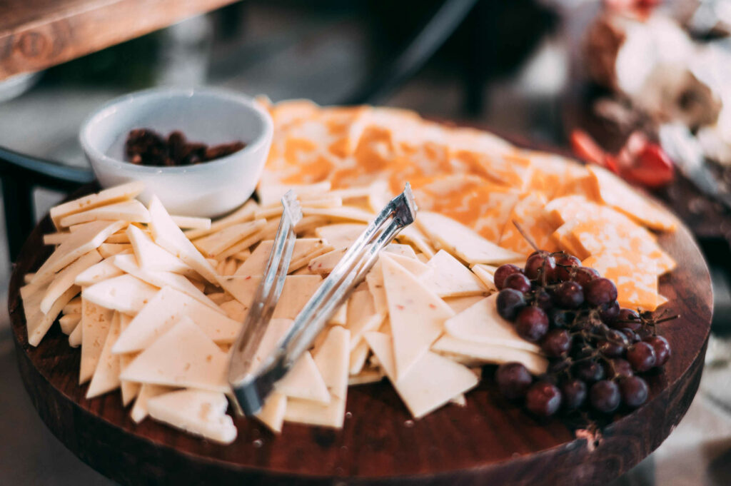 A cheese board is set out for guests during the cocktail hour of a Candlewood Inn wedding.