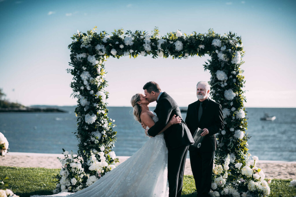 During their Madison Beach Club wedding, a bride and groom have their first kiss.