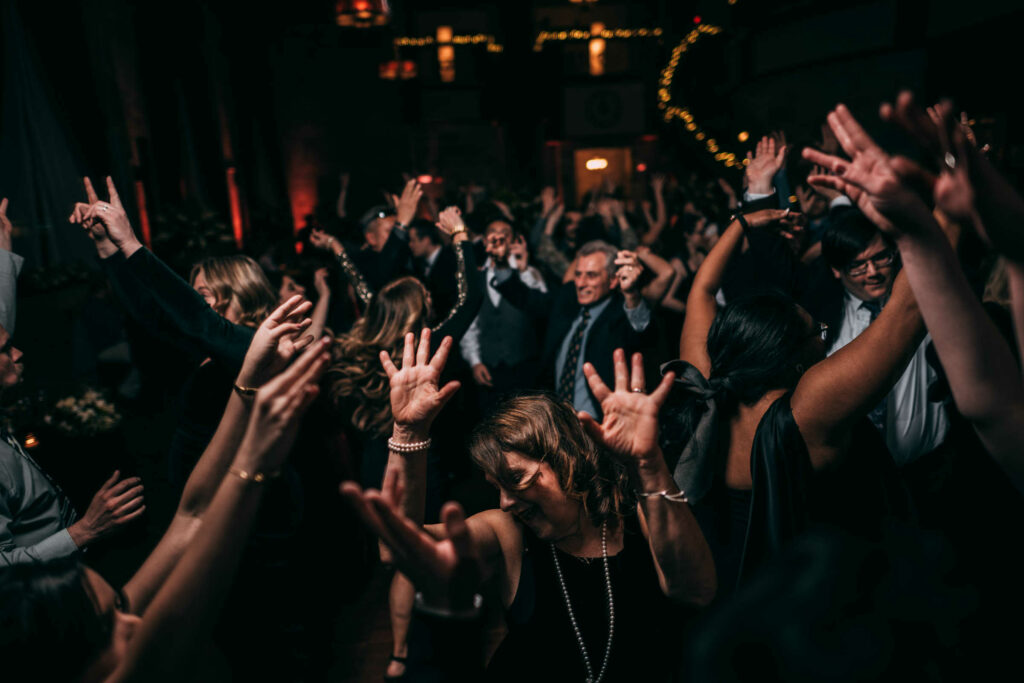 Guests dance together on the dance floor during a Society Room of Hartford wedding.