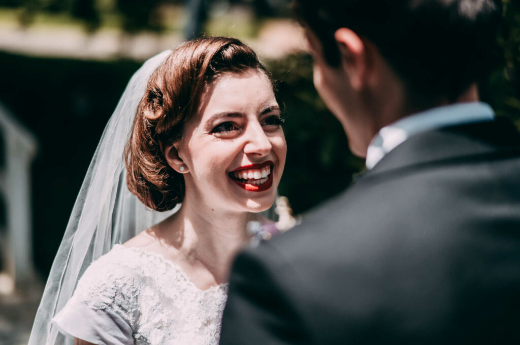 A bride smiles emphatically at her groom during their wedding at the Silver Fountain Inn in New Hampshire.