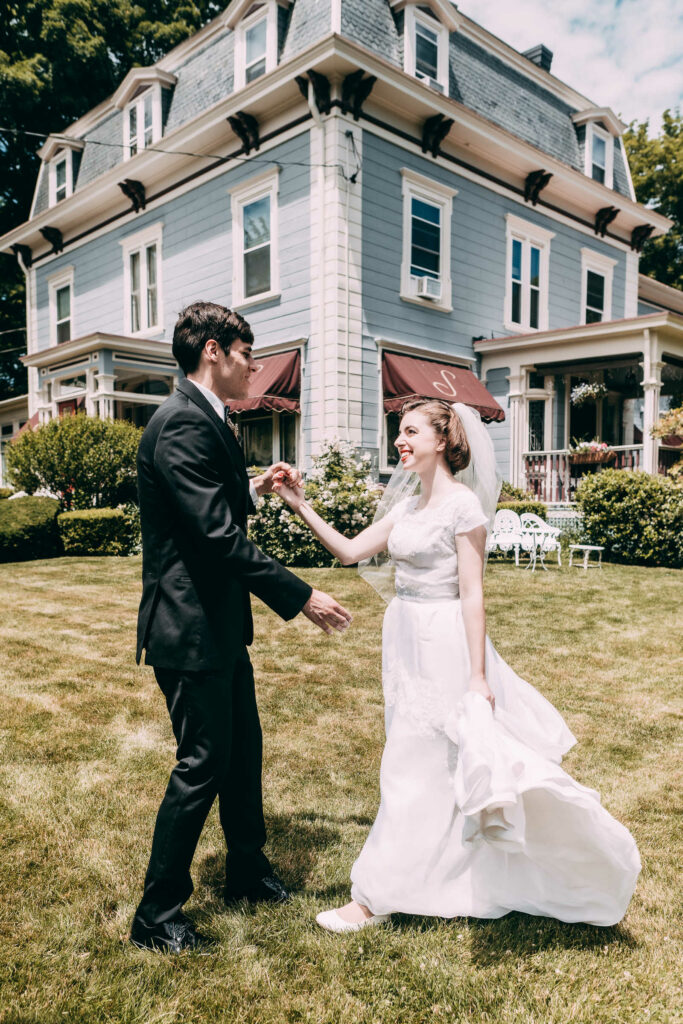 A bride and groom dance together outside the venue of their intimate New Hampshire wedding.