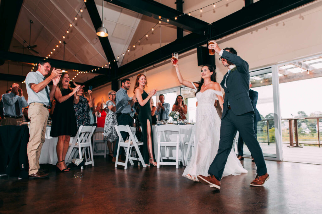 A couple enters their reception at Stony Creek, an excellent Connecticut brewery wedding venue.