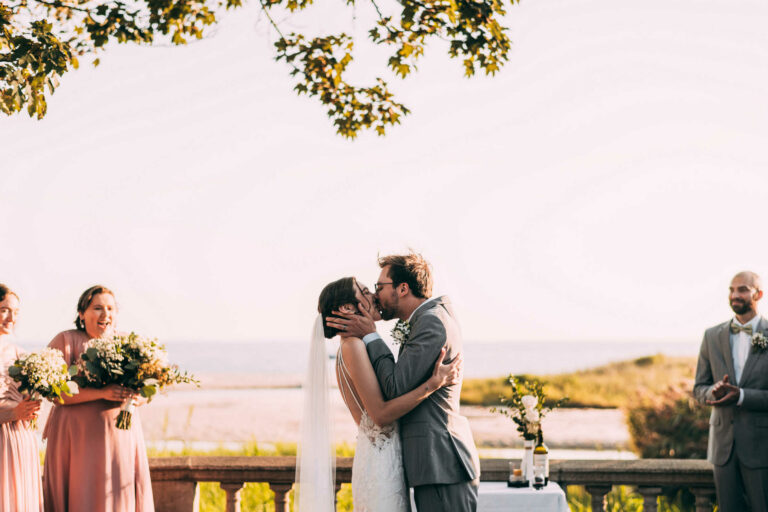 A bride and groom enjoy their first kiss during their Harkness Park wedding.